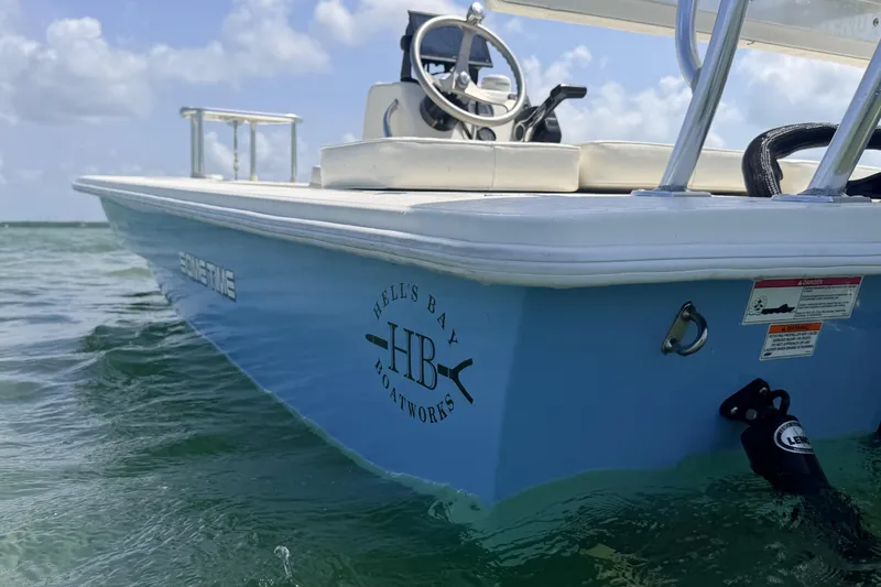 Slide: The Image of 2013 Hell's Bay Biscayne boat on water, showcasing sleek design and branding. - 21