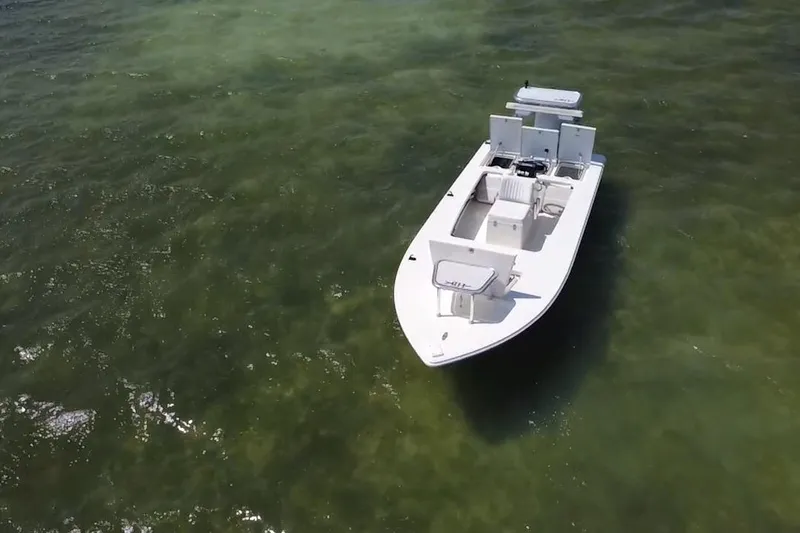 Slide: The Image of 2013 Hell's Bay Biscayne boat on clear green water, aerial view. - 9