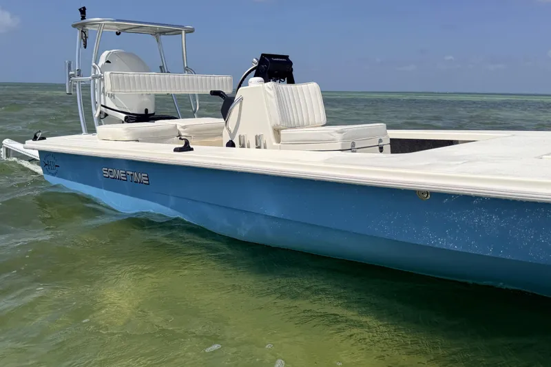 Slide: The Image of 2013 Hell's Bay Biscayne boat on clear water, featuring sleek design and comfortable seating. - 16