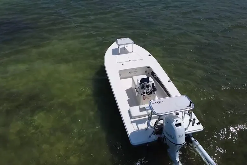 Slide: The Image of 2013 Hell's Bay Biscayne boat on clear green water, aerial view. - 7