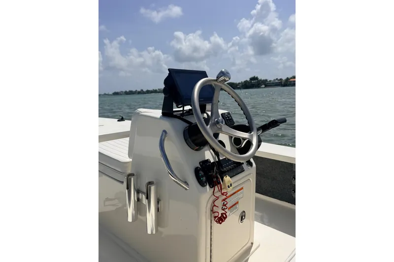 Slide: The Image of 2013 Hell's Bay Biscayne boat console with steering wheel, on a sunny day at sea. - 26
