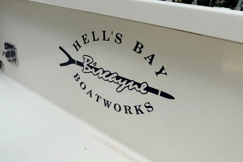 Slide: The Image of 2013 Hell's Bay Biscayne boat logo on white surface. - 29