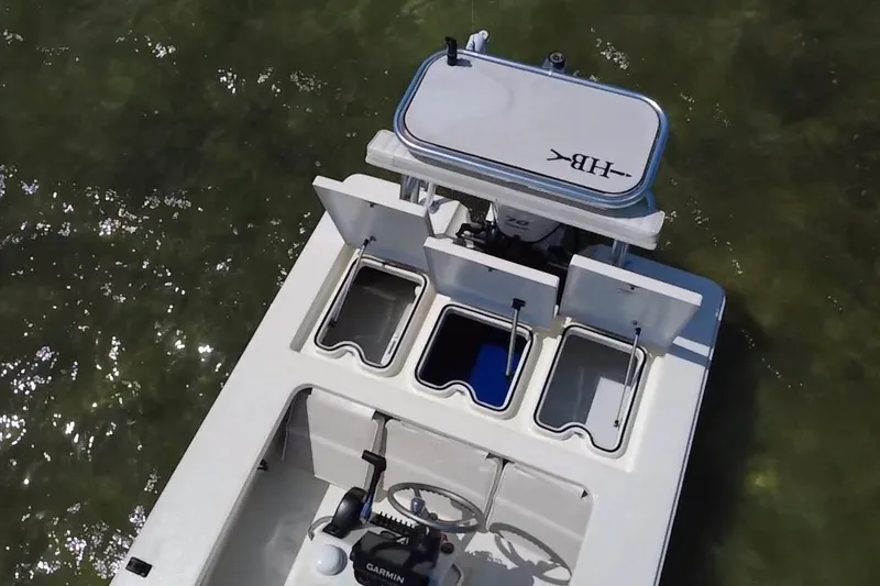 Slide: The Image of 2013 Hell's Bay Biscayne boat with open compartments, viewed from above in shallow water. - 11