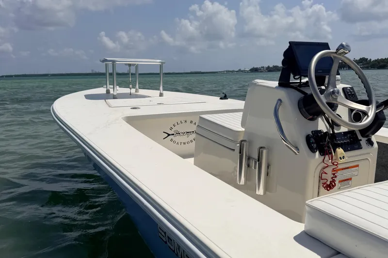 Slide: The Image of 2013 Hell's Bay Biscayne boat on calm water under a partly cloudy sky. - 23