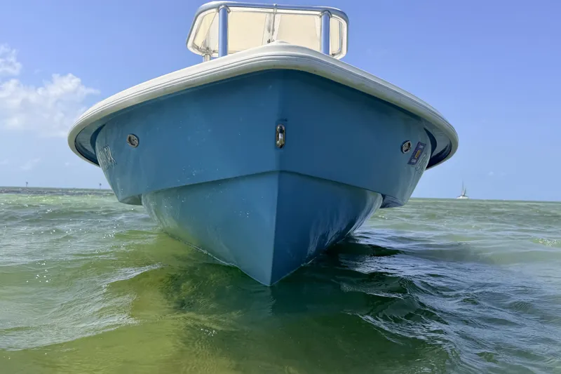 Slide: The Image of 2013 Hell's Bay Biscayne boat on clear green water under blue sky. - 19