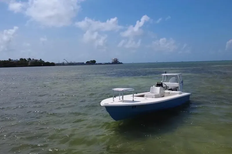 Slide: The Image of 2013 Hell's Bay Biscayne boat on calm waters under a clear blue sky. - 4