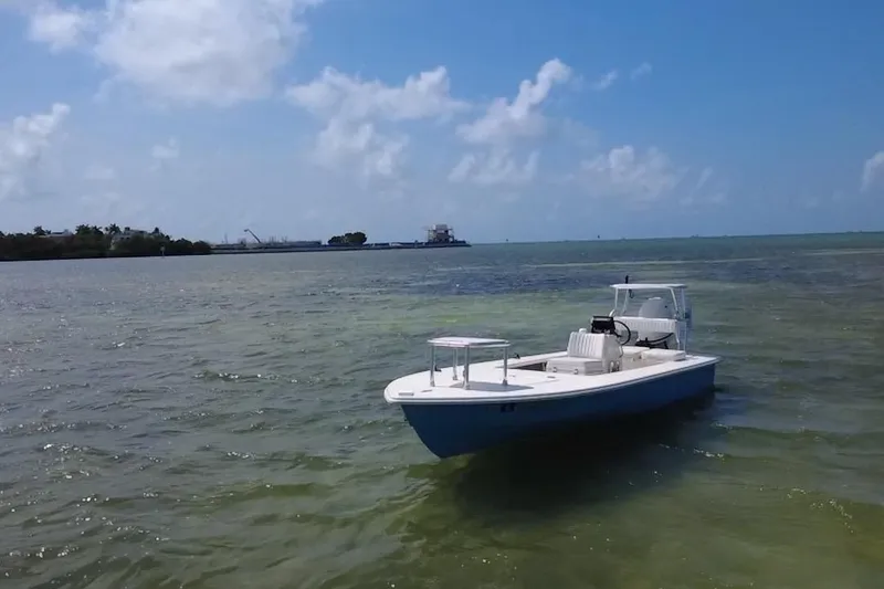 Slide: The Image of 2013 Hell's Bay Biscayne boat on calm waters under a clear blue sky. - 5