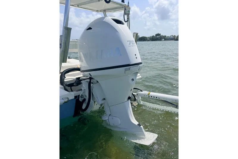 Slide: The Image of 2013 Hell's Bay Biscayne boat with Yamaha 70 outboard motor on water. - 25