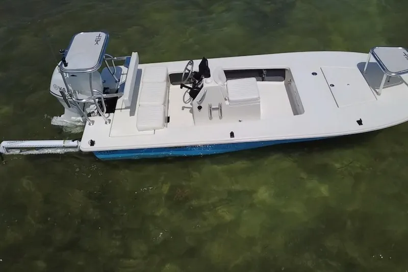 Slide: The Image of 2013 Hell's Bay Biscayne boat on clear shallow water, showcasing sleek design and functionality. - 8
