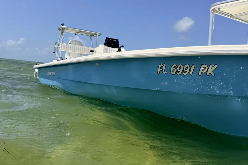 Slide: The Image of 2013 Hell's Bay Biscayne boat on clear water, registration FL 6991 PK. - 17