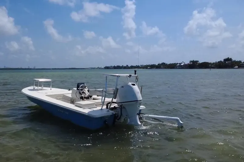 Slide: The Image of 2013 Hell's Bay Biscayne boat on calm waters under a clear blue sky. - 3