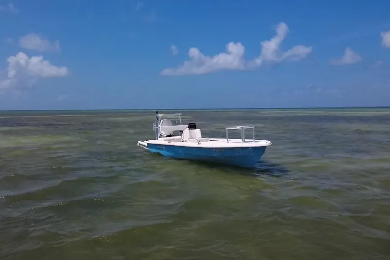 Slide: The Image of 2013 Hell's Bay Biscayne boat on calm, clear waters under a blue sky. - 2