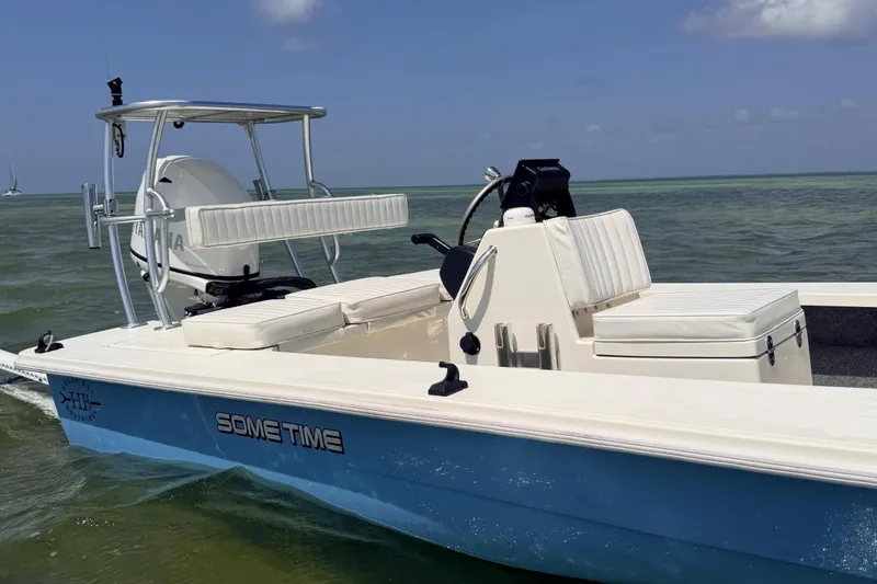 Slide: The Image of 2013 Hell's Bay Biscayne boat on water, featuring Yamaha engine and white seating. - 14