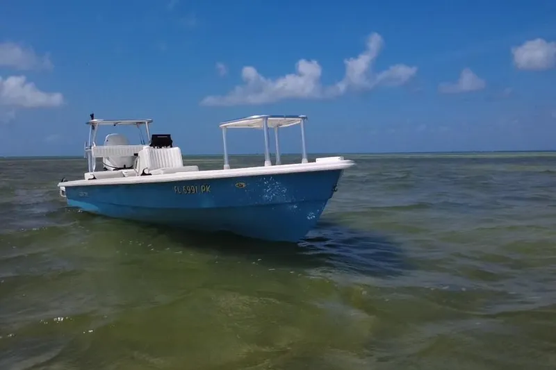 Slide: The Image of 2013 Hell's Bay Biscayne boat on calm waters under a clear blue sky. - 6