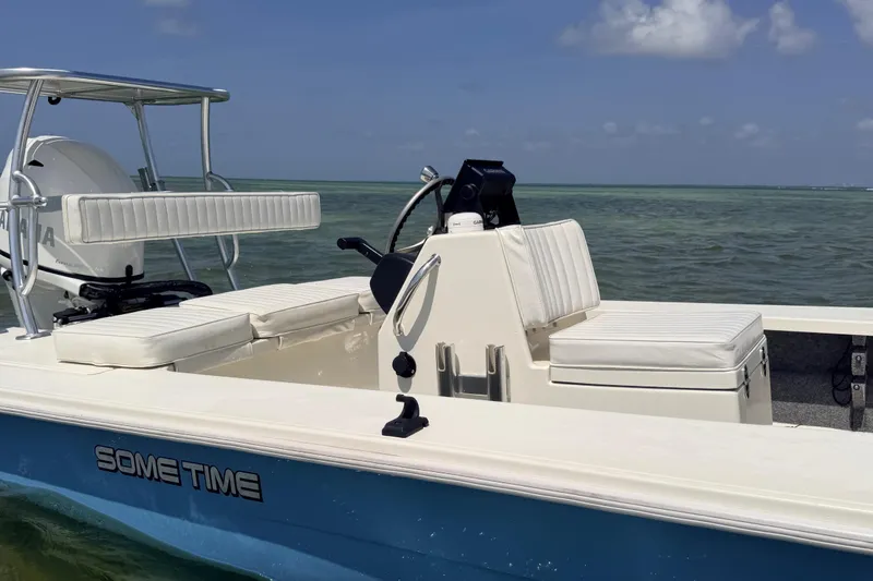 Slide: The Image of 2013 Hell's Bay Biscayne boat on water, featuring white seating and Yamaha engine. - 15