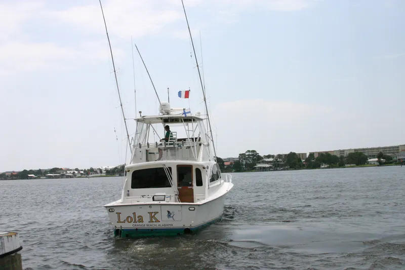 Slide: The Image of Ocean Yachts 48 Super Sport 2000 cruising on a calm waterway, rear view. - 2
