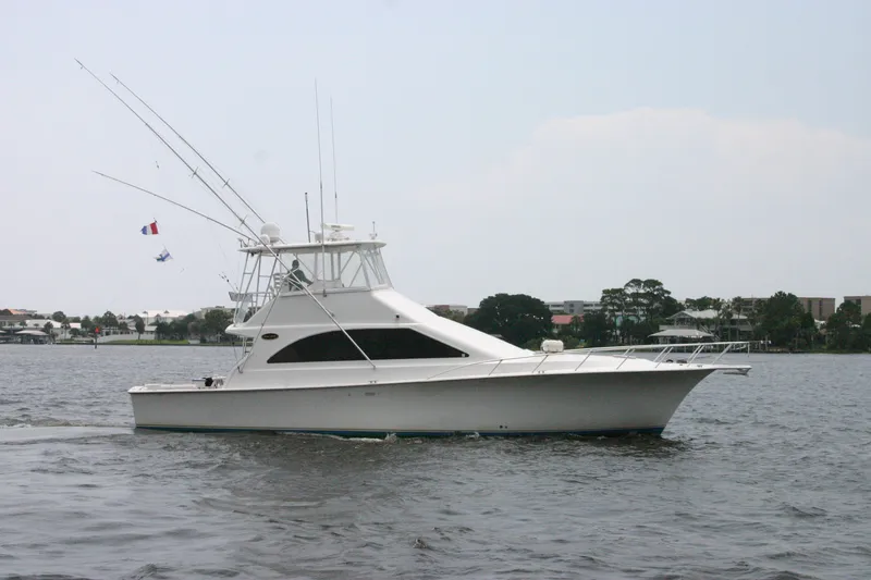 The Image of Ocean Yachts 48 Super Sport 2000 model cruising on a calm waterway. - 0