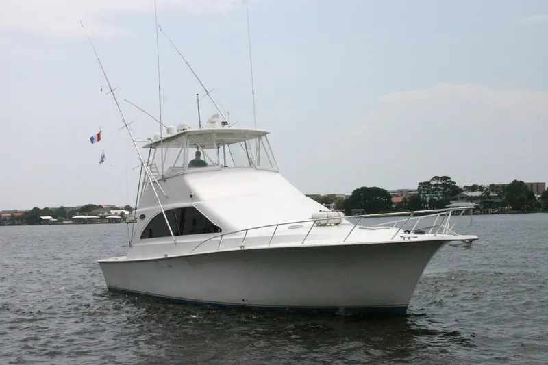 Slide: The Image of Ocean Yachts 48 Super Sport 2000 model cruising on a calm waterway. - 6