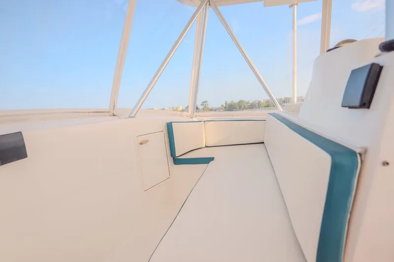 Slide: The Image of Interior view of a 2000 Ocean Yachts 48 Super Sport, featuring white and teal seating. - 22