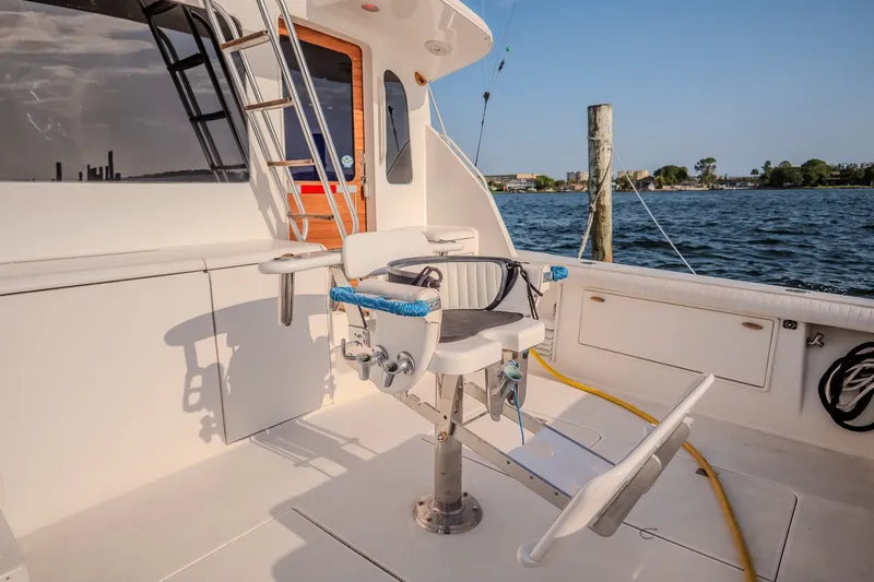 Slide: The Image of Fishing chair on 2000 Ocean Yachts 48 Super Sport, docked by the water. - 16