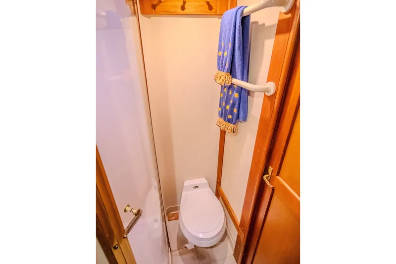 Slide: The Image of Bathroom interior of 2000 Ocean Yachts 48 Super Sport with towel rack and toilet. - 35