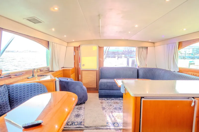 Slide: The Image of Luxurious interior of 2000 Ocean Yachts 48 Super Sport with elegant seating and wood finishes. - 24