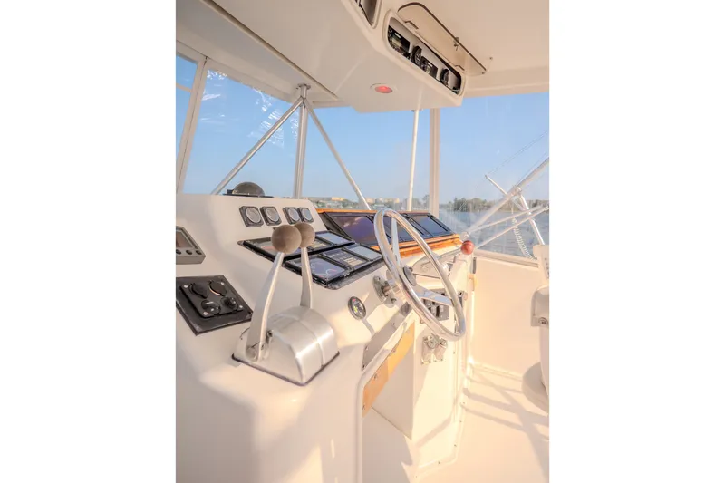 Slide: The Image of Helm of 2000 Ocean Yachts 48 Super Sport with steering wheel and controls. - 19
