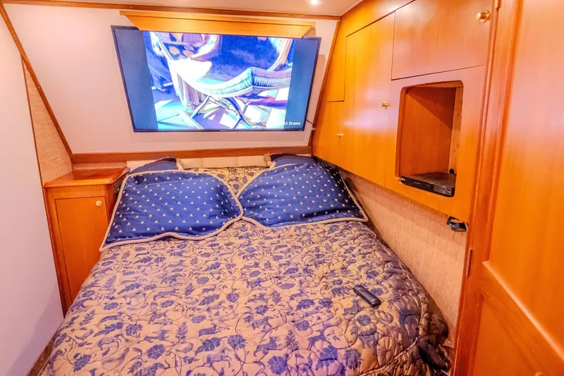 Slide: The Image of Luxurious cabin interior of 2000 Ocean Yachts 48 Super Sport with TV and cozy bedding. - 32
