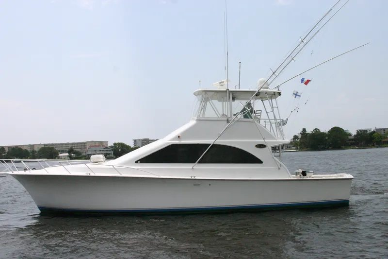 Slide: The Image of Ocean Yachts 48 Super Sport 2000 model cruising on a calm waterway. - 4
