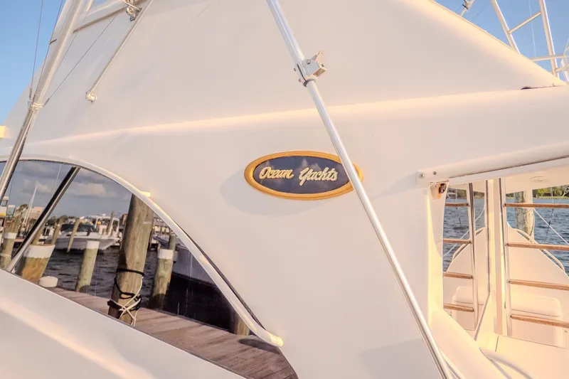 Slide: The Image of Ocean Yachts 48 Super Sport 2000 model docked at marina, showcasing sleek design. - 12