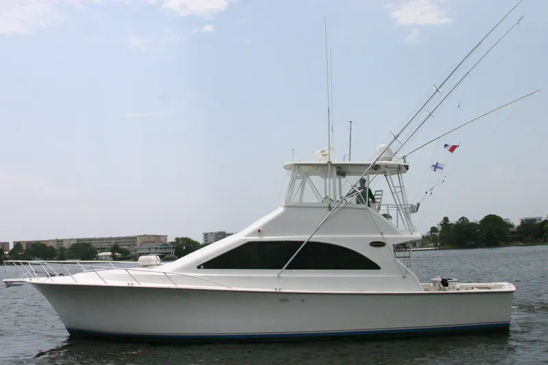 Slide: The Image of 2000 Ocean Yachts 48 Super Sport boat on calm water, side view. - 5