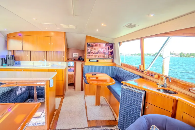 Slide: The Image of Luxurious interior of 2000 Ocean Yachts 48 Super Sport with wood finishes and waterfront view. - 26