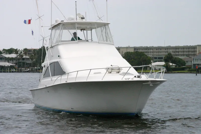Slide: The Image of 2000 Ocean Yachts 48 Super Sport cruising on calm waters, showcasing sleek design. - 7