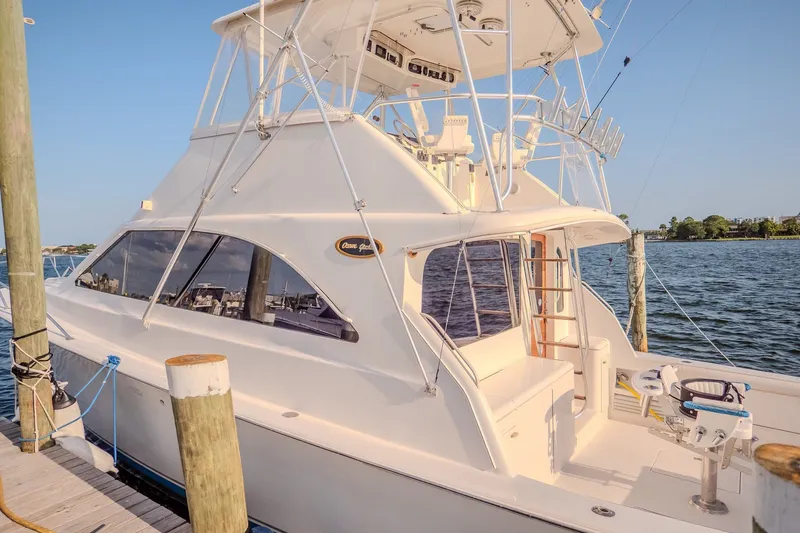 Slide: The Image of 2000 Ocean Yachts 48 Super Sport docked, showcasing sleek design and spacious deck. - 11