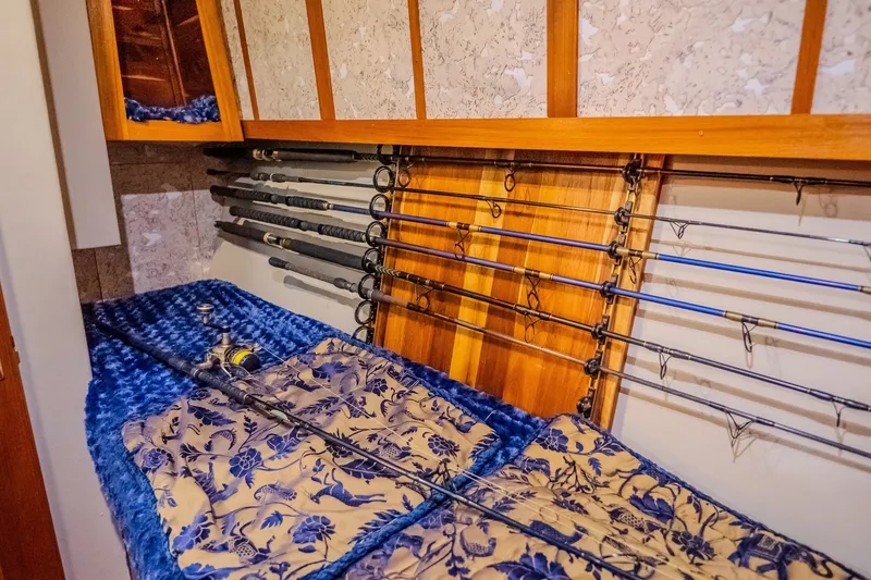 Slide: The Image of Fishing rods stored in a 2000 Ocean Yachts 48 Super Sport cabin. - 33