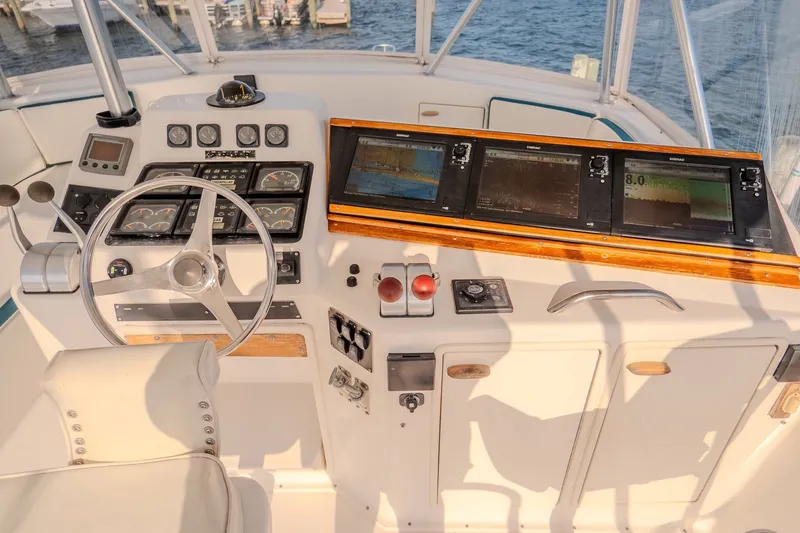 Slide: The Image of Cockpit of 2000 Ocean Yachts 48 Super Sport with navigation instruments and steering wheel. - 21