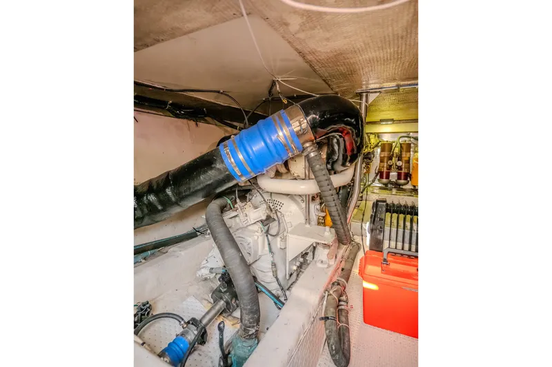 Slide: The Image of Engine room of 2000 Ocean Yachts 48 Super Sport, showcasing mechanical components and hoses. - 40