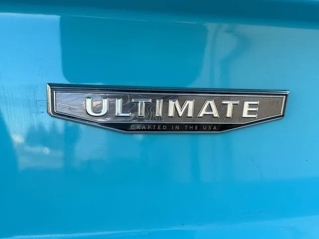 Slide: The Image of Close-up of the "Ultimate" emblem on a blue Regal LS6 boat. - 14