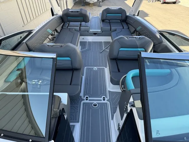 Slide: The Image of The image shows the spacious cockpit of a 2024 Regal LS6 boat with gray and blue seating. - 8