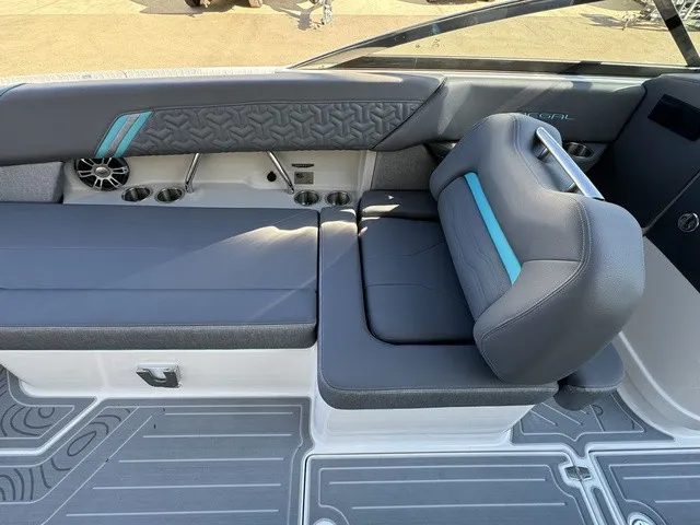 Slide: The Image of The image shows the interior of a 2024 Regal LS6 boat with gray upholstery and blue accents. - 20