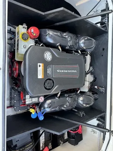 Slide: The Image of The engine compartment of a 2024 Regal LS6 boat features a Volvo Penta engine with various connections. - 9