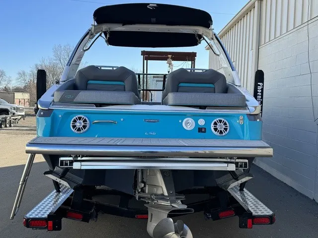 Slide: The Image of The image shows the rear of a 2024 Regal LS6 boat with blue trim. - 13