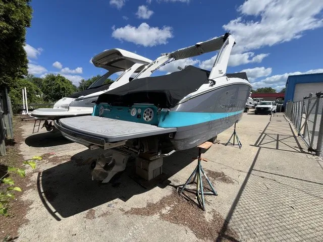 Slide: The Image of A 2024 Regal LS6 boat is on a dry dock under a blue sky. - 24