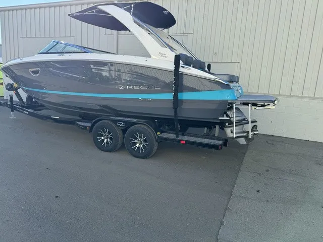 Slide: The Image of A 2024 Regal LS6 boat on a trailer, featuring a gray and blue color scheme. - 12
