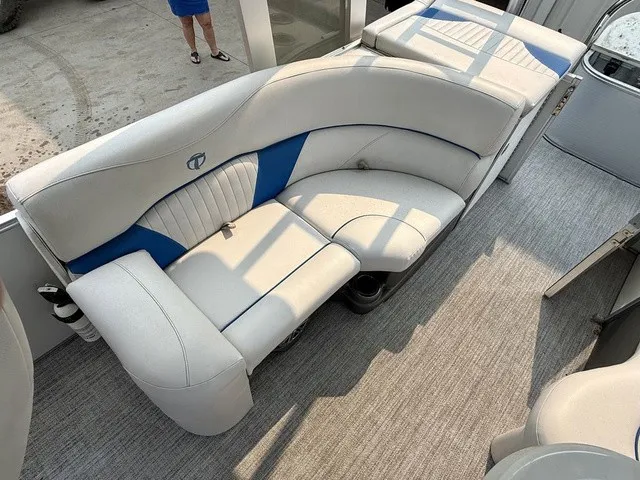 Slide: The Image of The image shows a white and blue bench seat on a boat with gray carpet flooring. - 15