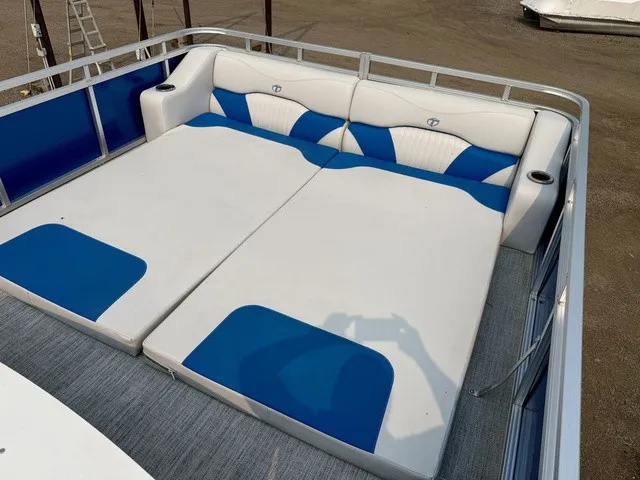Slide: The Image of The image shows the sun deck of a 2016 Tahoe 2785 Vista Fun Ship with blue and white cushions. - 17