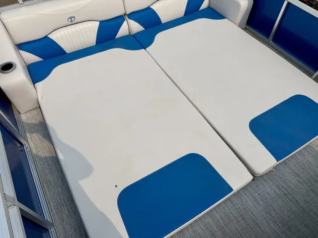 Slide: The Image of The image shows a lounging area on a boat with blue and white upholstery. - 19