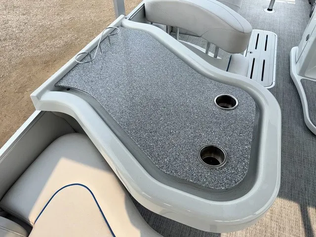 Slide: The Image of A gray table with two cup holders on a boat. - 22