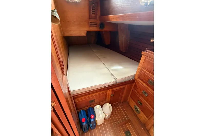 Slide: The Image of Cozy cabin interior of 1985 Shannon Ketch sailboat with wooden furnishings. - 7
