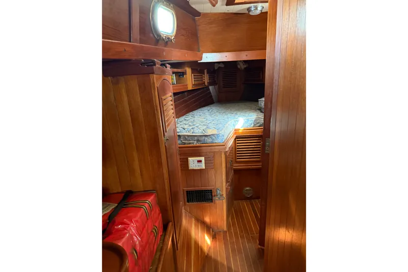 Slide: The Image of Cozy wooden cabin interior of 1985 Shannon Ketch sailboat with bed and porthole. - 13